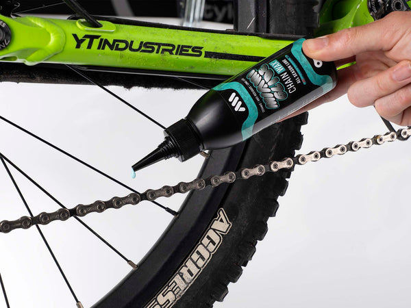 AMS Miami Glide Chain Wax 120ml being applied on a mtb chain