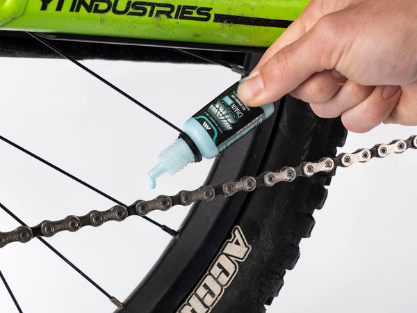 AMS Miami Glide Chain Wax 15ml version being applied on a mtb chain
